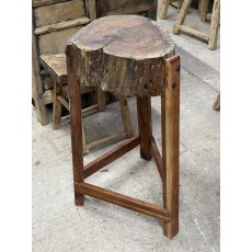 A Rustic Wooden Stump Butchers Block On Stand