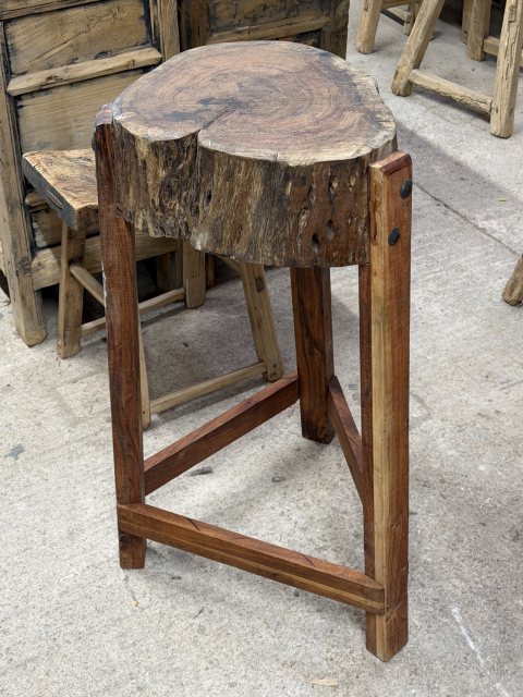 A Rustic Wooden Stump Butchers Block On Stand